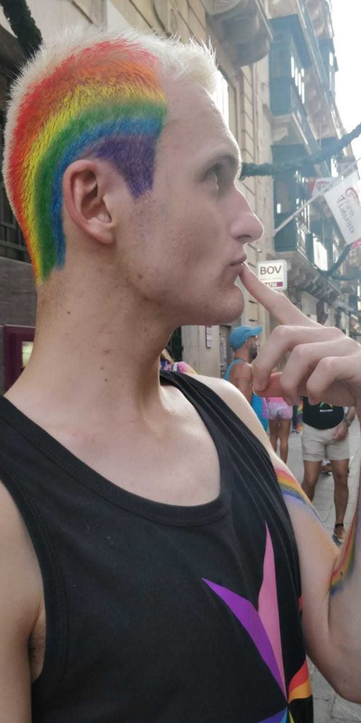 man with hair colour of rainbow pride