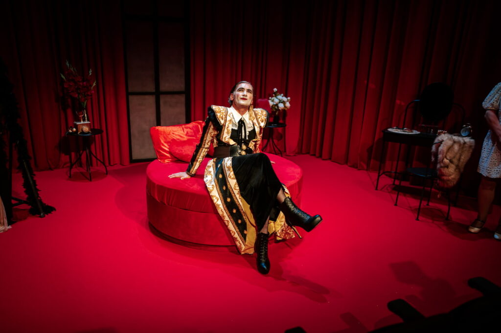 malcolm galea on a red bed in the maids
